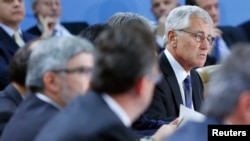 U.S. Defense Secretary Chuck Hagel (R) is seen at a NATO defense ministers meeting at the alliance's headquarters in Brussels October 22, 2013.