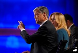 Debate moderators moderator John Harwood, left, moderator Becky Quick, center, and moderator Carl Quintanilla appear during the CNBC Republican presidential debate at the University of Colorado, Wednesday, Oct. 28, 2015.