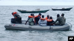 FILE - Cameroonian coast guardsmen and marines are seen in a rescue boat near the port town of Kribi, Cameroon. Thirty-two people, most of them Cameroonian soldiers, remain unaccounted for after their ship sank off the coast of the Bakassi Peninsula over a week ago.