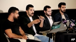 Lebanese Hamed Sinno, second left, lead singer and song writer of the Lebanese group Mashrou' Leila or "Leila's Project" band, speaks during a press conference with his band musicians, in Beirut, Lebanon, Thursday, April 28, 2016.