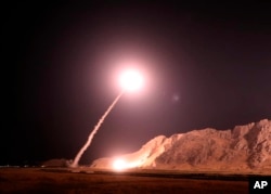 FILE - In this photo released on Oct. 1, 2018, by the Iranian Revolutionary Guard, a missile is fired from city of Kermanshah in western Iran targeting the Islamic State group in Syria.