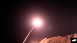 In this photo released on Oct. 1, 2018, by the Iranian Revolutionary Guard, a missile is fired from city of Kermanshah in western Iran targeting the Islamic State group in Syria.