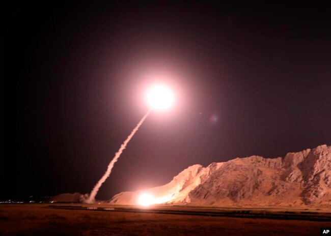 In this photo released on Oct. 1, 2018, by the Iranian Revolutionary Guard, a missile is fired from city of Kermanshah in western Iran targeting the Islamic State group in Syria.