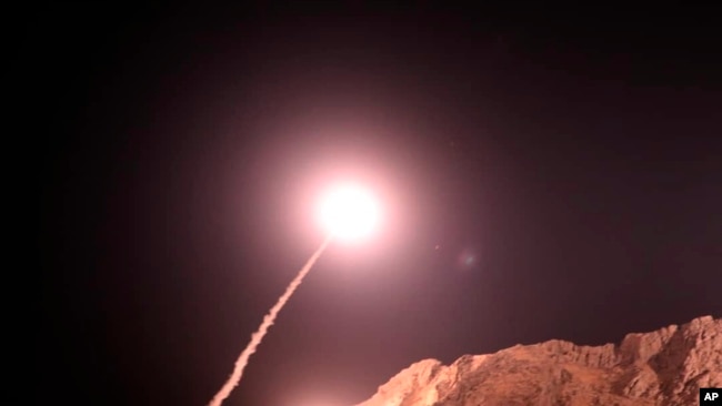 In this photo released on Oct. 1, 2018, by the Iranian Revolutionary Guard, a missile is fired from city of Kermanshah in western Iran targeting the Islamic State group in Syria.