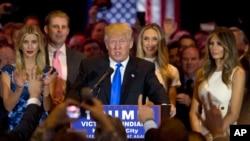 Republican presidential candidate Donald Trump is joined by his wife Melania, right, daughter Ivanka, left, and son Eric, background left, as he speaks during a primary night news conference, May 3, 2016, in New York. 