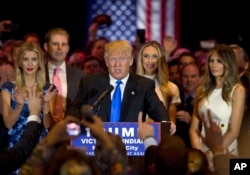 Republican presidential candidate Donald Trump is joined by his wife Melania, right, daughter Ivanka, left, and son Eric, background left, as he speaks during a primary night news conference, May 3, 2016, in New York.
