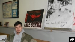 Zah Win in his Buffalo, New York, laundromat where the walls are covered with posters denouncing Burma’s military junta.
