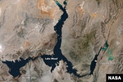 The image shows Lake Mead on the Nevada-Arizona state border at its highest point ever, taken by the Thematic Mapper on the Landsat 5 satellite, May 1984.