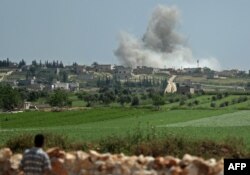 Smoke billows after reported shelling on the Syrian village of Kafr Ein in the southern countryside of the jihadist-held Idlib province, Syria, May 2, 2019.