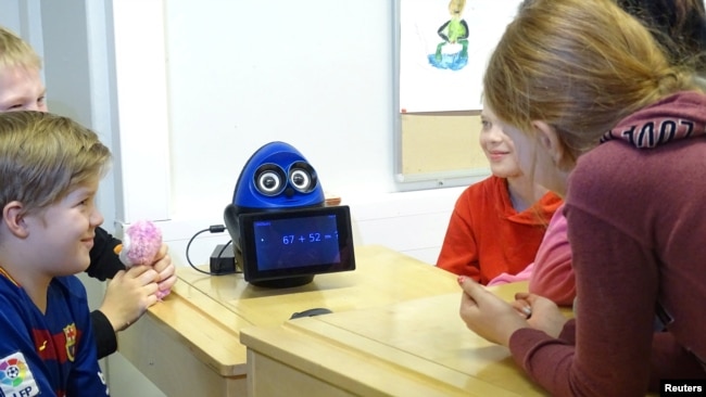 FILE - Students use a mathematics teaching robot, OVObot, during their lesson at the school in Tampere, Finland, March 27, 2017. (REUTERS/Attila Cser)