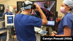 Stanford Director of Neurosurgery Dr. Gary Steinberg joins Malie Collins for a final refresher of the location of the aneurysm before Steinberg begins the surgery. Collins is the program manager of the Stanford Neurological Simulation & Virtual Reality Center.