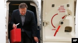 FILE - Britain's Prime Minister David Cameron is seen stepping off a plane in a June 16, 2013, photo.