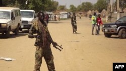 FILE - A soldier from South Sudan's army stands guard in Malakal in the Upper Nile State of South Sudan, Dec. 31, 2013.