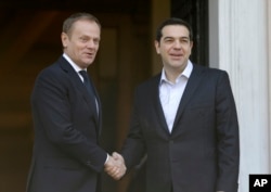 Greece's Prime Minister Alexis Tsipras, right, poses with European Council President Donald Tusk for a photo before their meeting at Maximos Mansion in Athens, March 3, 2016.