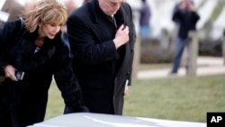 Diana Rambo and her husband pause at a casket of unidentified remains after services to honor two sailors from the USS Monitor, at Arlington National Cemetery, March 8, 2013 in Arlington. Mrs. Rambo is related to USS Monitor crew member Jacob Nicklis.