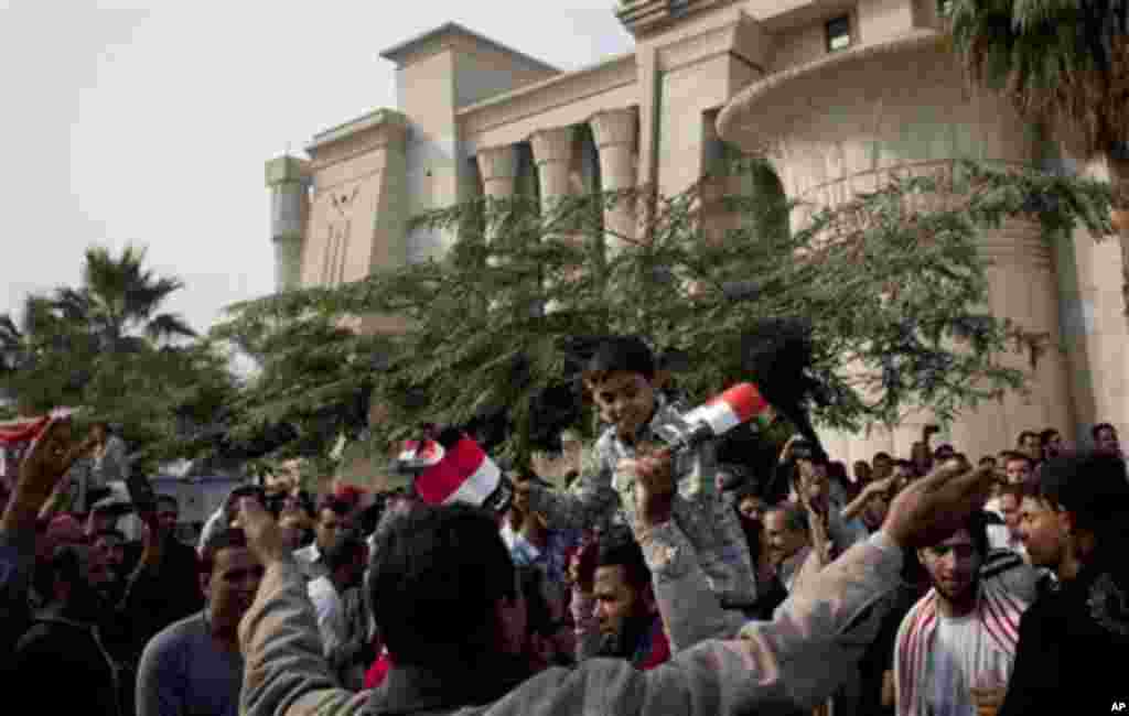 Supporters of Egyptian President Mohammed Morsi chant slogans in front of Egypt’s top court, background, in Cairo, Egypt, Sunday, Dec. 2, 2012. Egypt’s top court announced on Sunday the suspension of its work indefinitely to protest “psychological and physical pressures,” saying its judges could not enter its Nile-side building because of the Islamist president’s supporters gathered outside. (AP Photo/Nasser Nasser)