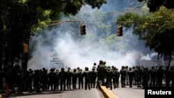Riot police take position while clashing with opposition supporters during a rally against President Nicolas Maduro in Caracas, Venezuela, May 4, 2017. 