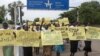 Women march carrying placards with messages demanding peace and their rights, on the streets of South Sudan's capital, Juba, July 13, 2018.