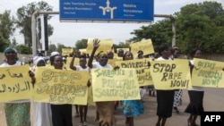 Women march carrying placards with messages demanding peace and their rights, on the streets of South Sudan's capital, Juba, July 13, 2018.