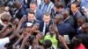 French President Emmanuel Macron (C) meets residents as he leaves the Ouagadougou University after giving a speech, Nov. 28, 2017, in Ouagadougou, as part of his first African tour since taking office.