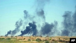 Smoke rises after airstrikes by U.S.-led coalition warplanes as Iraqi security forces advance their positions in the southern neighborhoods of Fallujah to retake the city from Islamic State militants, Iraq, June 12, 2016.