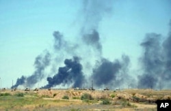 Smoke rises after airstrikes by U.S.-led coalition warplanes as Iraqi security forces advance their positions in the southern neighborhoods of Fallujah to retake the city from Islamic State militants, Iraq, June 12, 2016.
