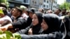 FILE - Iranians attend the funeral of victims of an Islamic State militant attack, in Tehran, Iran, June 9, 2017. Attacks claimed by Islamic State killed 17 people. 