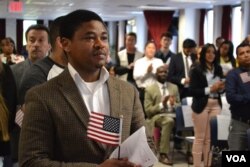 Chijioke Anyira, from Nigeria, awaits the administration of oath. “I hold it in very high esteem to be an American,” said Anyira, after the ceremony. (R. Taylor/VOA)