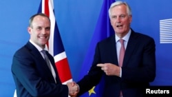 Britain's Secretary of State for Exiting the European Union, Dominic Raab and European Union's chief Brexit negotiator, Michel Barnier, pose ahead of a meeting in Brussels, Belgium, July 19, 2018.