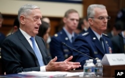 Defense Secretary Jim Mattis, left, accompanied by Joint Chiefs Vice Chairman General Paul J. Selva, speaks during a hearing of the House Armed Services Committee on Capitol Hill, Feb. 6, 2018, in Washington.