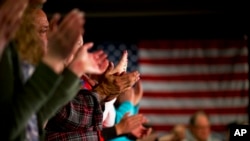 Supporters clap while listening to Democratic presidential candidate Sen. Bernie Sanders, at a campaign event in Maquoketa, Iowa, Jan. 23, 2016. 