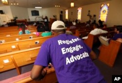 A man listens as Black Voters Matter co-founder LaTosha Brown speaks at a church as part of The South Is Rising Tour 2018 on Aug. 22, 2018, in Warner Robins, Ga.