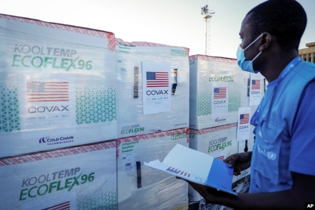 FILE - A worker checks boxes of a coronavirus vaccine following their delivery at the airport in Nairobi, Kenya, Aug. 23, 2021. (AP Photo/Brian Inganga, File)