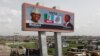 An electronic billboard with opposition presidential candidate, Muhammadu Buhari, of the All Progressives Congress party and his running mate, Yemi Osinbanjo is seen at a slum in Lagos, Nigeria, Tuesday, March. 24, 2015. 