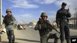 Afghan police keep watch at a checkpoint in Kabul, April 10, 2012. 