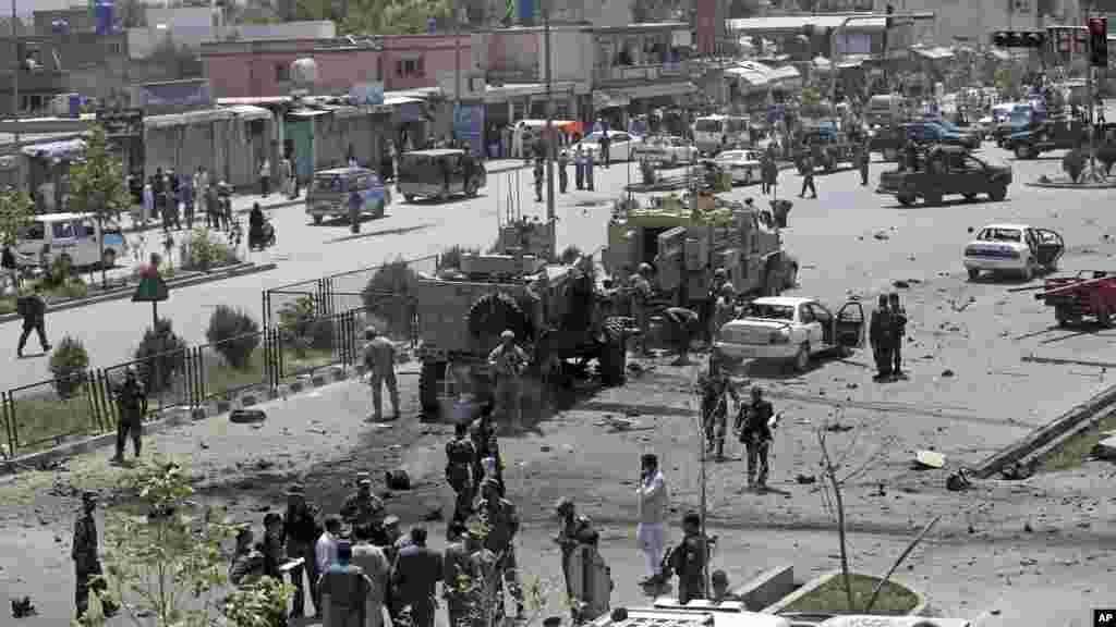 NATO and Afghanistan's security forces inspect at the site of a suicide attack in Kabul, Afghanistan, Aug. 10, 2014. 