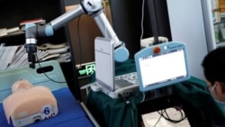 This photo shows a robot designed to help medical workers treat coronavirus patients remotely is pictured during a demonstration for the media at the aerospace engineering school of Tsinghua University in Beijing, China March 4, 2020. (REUTERS/Carlos Garc