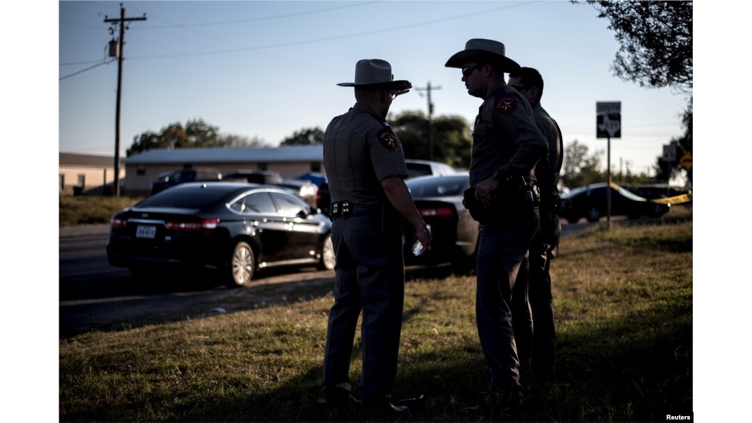 Members of the Wilson County Sheriff's office stand inside a taped off area near the First Baptist Church in Sutherland Springs, Texas, Nov. 5, 2017.