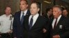 Harvey Weinstein (kedua dari kanan) diborgol tangannya saat dibawa memasuki ruang sidang di pengadilan New York, Senin (9/7). 