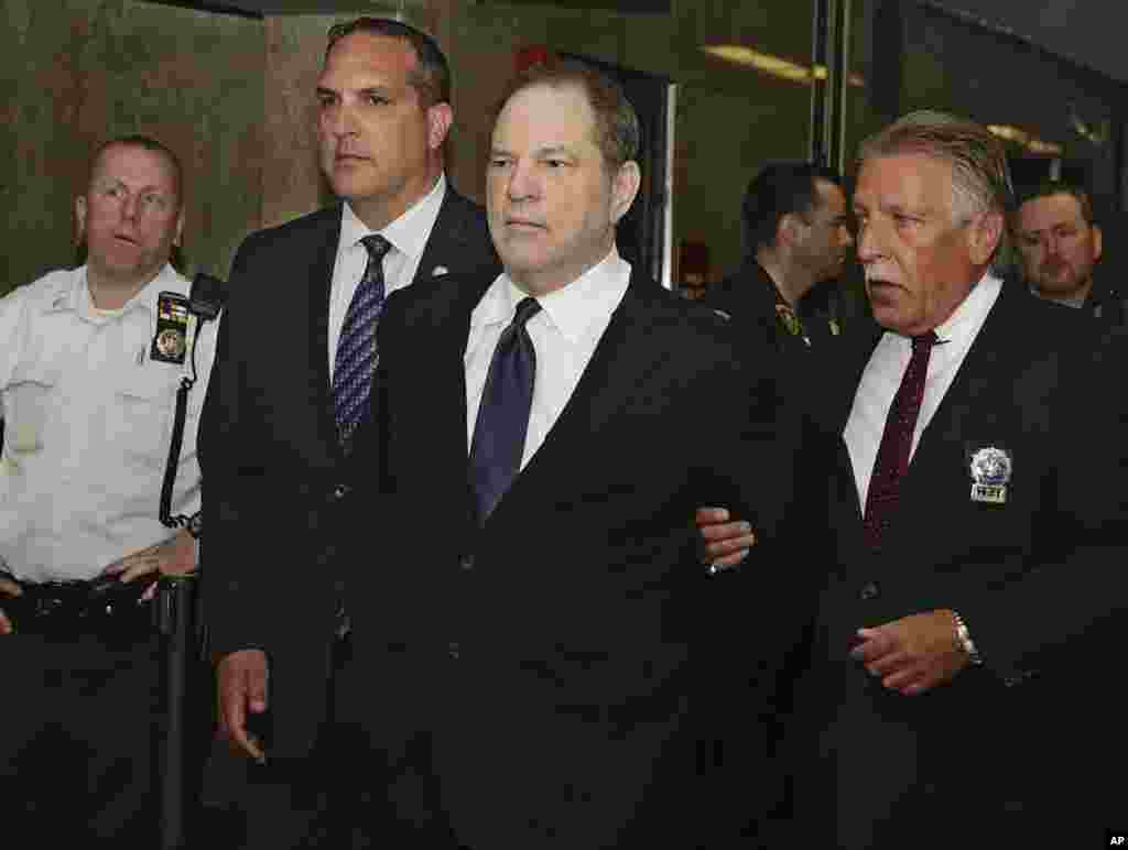 Former Hollywood film producer Harvey Weinstein is escorted in handcuffs to a courtroom in New York. Weinstein, who was previously indicted on charges involving two women, was due in court for arraignment on charges alleging he committed a sex crime against a third woman.