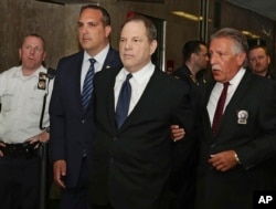 Harvey Weinstein is escorted in handcuffs to a courtroom in New York, July 9, 2018.