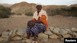 Abdu Ibrahim Mohammed, a retired salt merchant, poses for a photograph close to his home in the town of Berahile in Afar, northern Ethiopia, April 20, 2013.