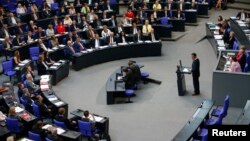 Cem Oezdemir of the environmental Greens party (Die Gruenen) addresses a session of the Bundestag, lower house of parliament, being held to debate approval of a symbolic resolution that declares the 1915 massacre of Armenians by Ottoman forces a "genocide