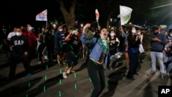 People gather at Plaza Italia on the day Chileans voted in a referendum to decide whether the country should replace its 40-year-old constitution, written during the dictatorship of Gen. Augusto Pinochet, in Santiago, Chile, Oct. 25, 2020. (AP)