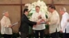 FILE - Philippine President Benigno Aquino (C) applauds as Moro Islamic Liberation Front (MILF) chief negotiator Mohagher Iqbal (2nd L) shakes hands with Senate President Franklin Drilon (2nd R) during the turnover ceremony of the draft Bangsamoro Basic Law (BBL).