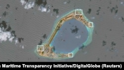 A satellite image shows what CSIS Asia Maritime Transparency Initiative says appears to be anti-aircraft guns and what are likely to be close-in weapons systems (CIWS) on the artificial island Subi Reef in the South China Sea in this image released on Dec. 13, 2016.