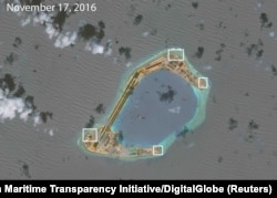 FILE - A satellite image shows what CSIS Asia Maritime Transparency Initiative says appears to be anti-aircraft guns and what are likely to be close-in weapons systems (CIWS) on the artificial island Subi Reef in the South China Sea.
