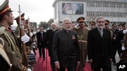 Indian Prime Minister Narendra Modi, left, is escorted by Afghan Chief Executive Abdullah Abdullah as he leaves Kabul at the city's airport, Dec. 25, 2015.