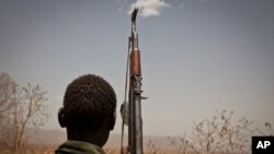 A Sudan People's Liberation Movement rebel soldier looks out toward Talodi, in South Kordofan, a region of Sudan on April 25, 2012.