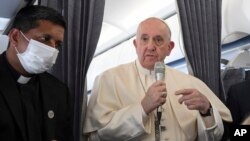 Pope Francis greets journalists onboard the papal plane on the occasion of his pastoral visit to Cyprus and Greece, Dec. 6, 2021. (Alessandro Di Meo/Pool photo via AP)